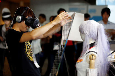 A man rects as he tries out a M2 Co.Ltd's "E-mote" system at Tokyo Game Show 2016 in Chiba, east of Tokyo, Japan, September 15, 2016. REUTERS/Kim Kyung-Hoon