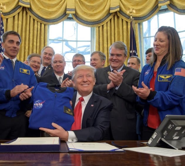 President Donald Trump shows off a flight jacket he was given after signing a NASA authorization bill into law in 2017. (NASA Photo / Bill Ingalls)