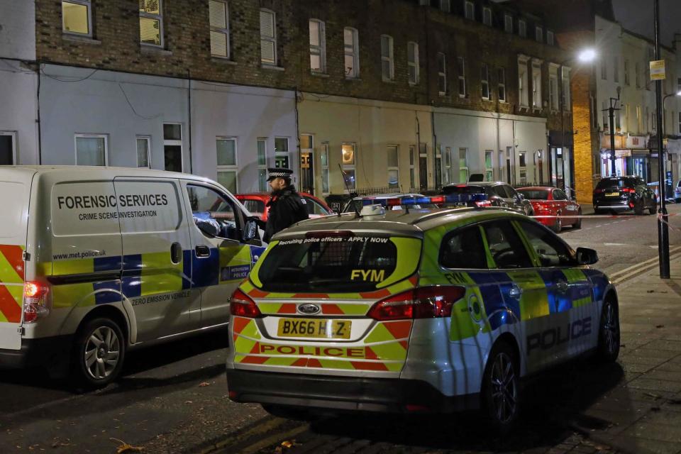 Police vehicles lined the street near the scene where the teenager was stabbed to death in Hackney (NIGEL HOWARD)