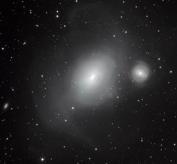 This new image from the MPG/ESO 2.2-metre telescope at ESO’s La Silla Observatory in Chile shows a contrasting pair of galaxies: NGC 1316, and its smaller companion NGC 1317 (right).