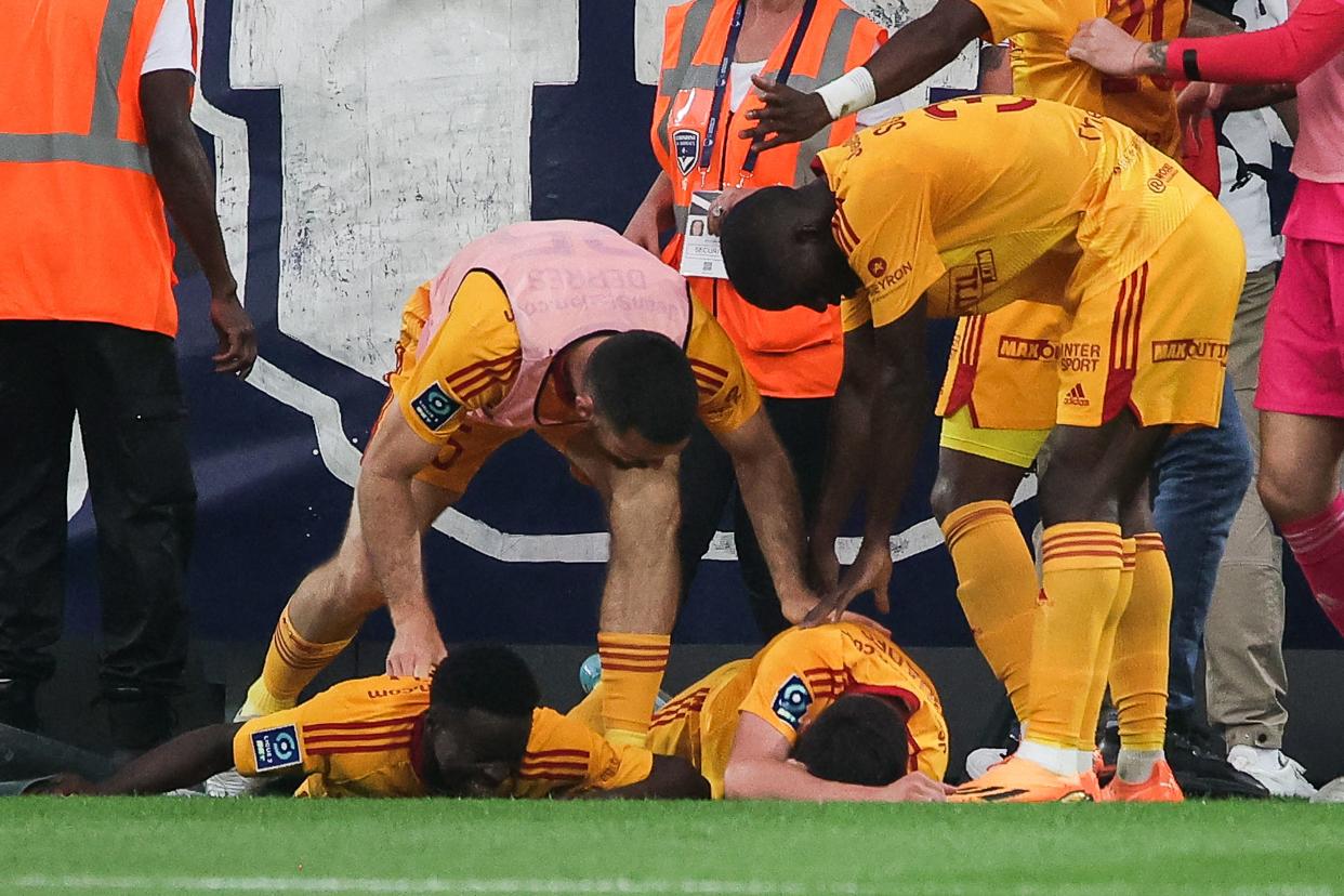 Rodez' French midfielder Lucas Buades (C) lies on the ground after being hit by a projectile during the French L2 football match between FC Girondins de Bordeaux and Rodez AF at the Matmut Atlantique Stadium in Bordeaux, on June 2, 2023. (Photo by THIBAUD MORITZ / AFP) (Photo by THIBAUD MORITZ/AFP via Getty Images)