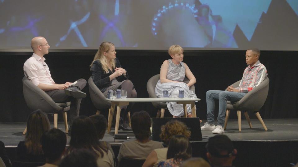 From left to right, TIME journalist Billy Perrigo, Facebook whistleblower Frances Haugen, Foxglove director Cori Crider, and ex-Facebook moderator Daniel Motaung, sit round a table on a stage.