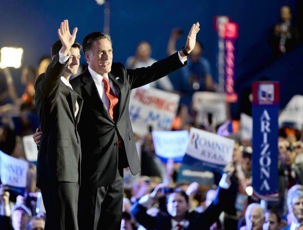 Paul Ryan, left, joins Mitt Romney after the Republican presidential nominee's acceptance speech in Tampa, Fla.