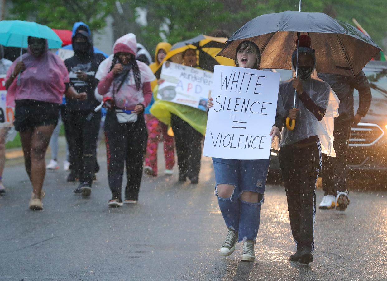 Protesters march in the rain Friday along Fess Avenue in Akron in support of Jayland Walker.