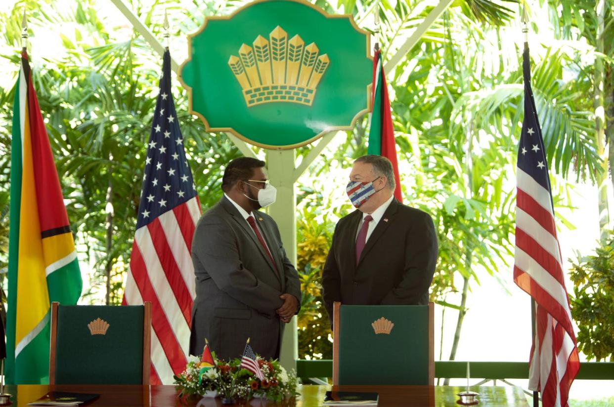 <span class="caption">Secretary of State Mike Pompeo with Guyana's president, Mohamed Irfaan Ali, Sept. 18. Pompeo is the first U.S. secretary of state to visit the tiny South American country. </span> <span class="attribution"><a class="link " href="https://www.gettyimages.com/detail/news-photo/secretary-of-state-mike-pompeo-speaks-with-guyanas-news-photo/1228580460?adppopup=true" rel="nofollow noopener" target="_blank" data-ylk="slk:AFP via Getty Images;elm:context_link;itc:0;sec:content-canvas">AFP via Getty Images</a></span>