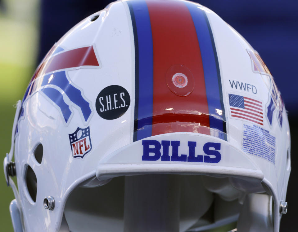 FILE - This Dec. 30, 2012, file photo shows a Buffalo Bills helmet displaying a WWFD (West Webster Fire Department) decal in memory of two fallen West Webster, N.Y., firefighters who lost their lives in a shooting and a S.H.E.S. decal in honor of the victims of the Sandy Hook Elementary School shootings, before an NFL football game against the New York Jets in Orchard Park, N.Y. The NFL is planning to allow players to have decals on the back of their helmets bearing names or initials of victims of systemic racism and police violence. The league has been in talks with individual players and their union since June about somehow honoring such victims. (AP Photo/Gary Wiepert, File)