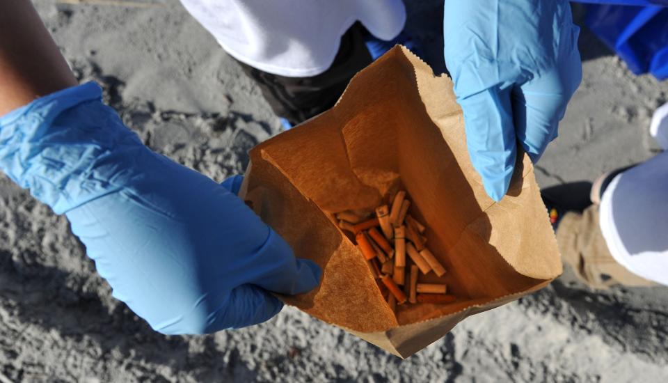 Dylan Arnold shows how many cigarette butts he had collected in the first 20 minutes during a 2011 Jacksonville Beach cleanup. Atlantic Beach this week passed a law prohibiting smoking cigarettes in public parks, on the beach and at beach accesses, citing environmental and health issues.