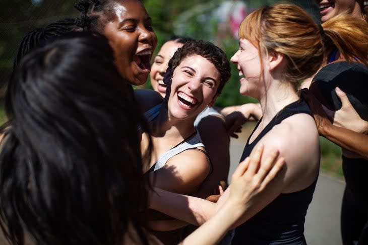 Multiracial women embracing each other with joy after a run