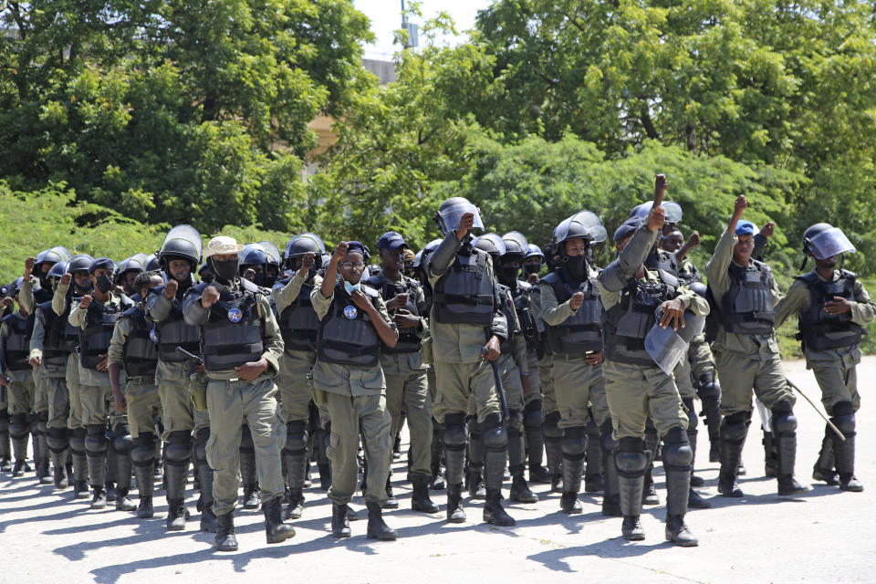 Police officers rehearse ahead of the soccer league match between Hirshabele and Jubaland at a stadium in Mogadishu, Somalia, Tuesday, Jan 23, 2024. A stadium in the violence-prone Somali capital is hosting its first soccer tournament in three decades, drawing thousands of people to a sports facility that had fallen into disuse and later became a military base amid civil war.(AP Photo/Farah Abdi Warsameh)