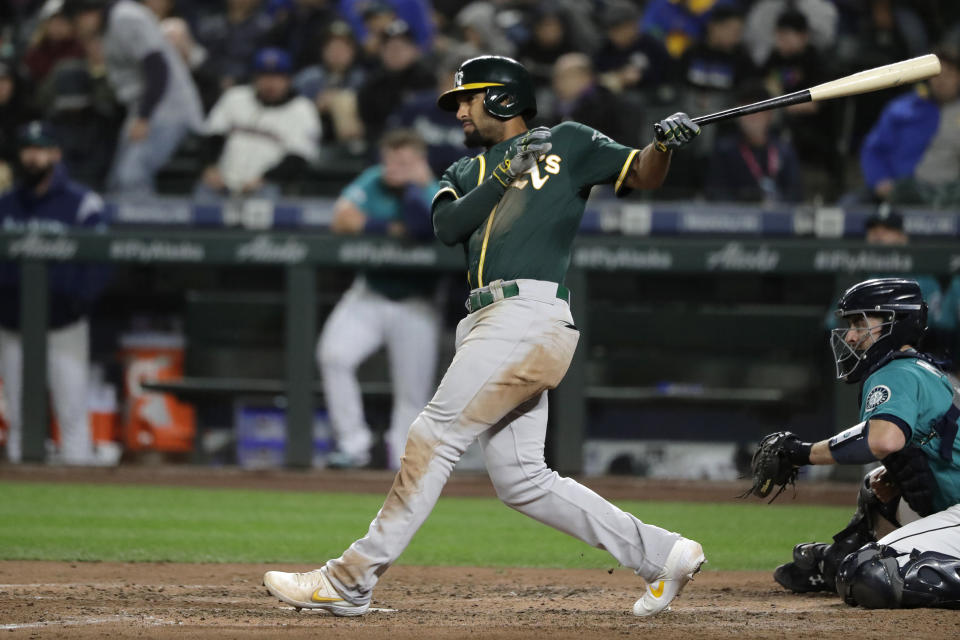 Oakland Athletics' Marcus Semien follows through on a line out to left field during the sixth inning of a baseball game against the Seattle Mariners, Friday, Sept. 27, 2019, in Seattle. (AP Photo/Ted S. Warren)