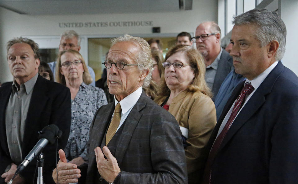 Attorney for clergy abuse survivors Jeff Anderson stands in front of survivors after a U.S. Bankruptcy Court approved a settlement that includes $210 million for victims of clergy sex abuse, Tuesday, Sept. 25, 2018, in Minneapolis. A U.S. Bankruptcy Court judge has approved a reorganization plan for the Archdiocese of St. Paul and Minneapolis that will compensate victims of clergy sex abuse. Hundreds of victims voted overwhelmingly in favor of the plan. (Shari L. Gross/Star Tribune via AP)