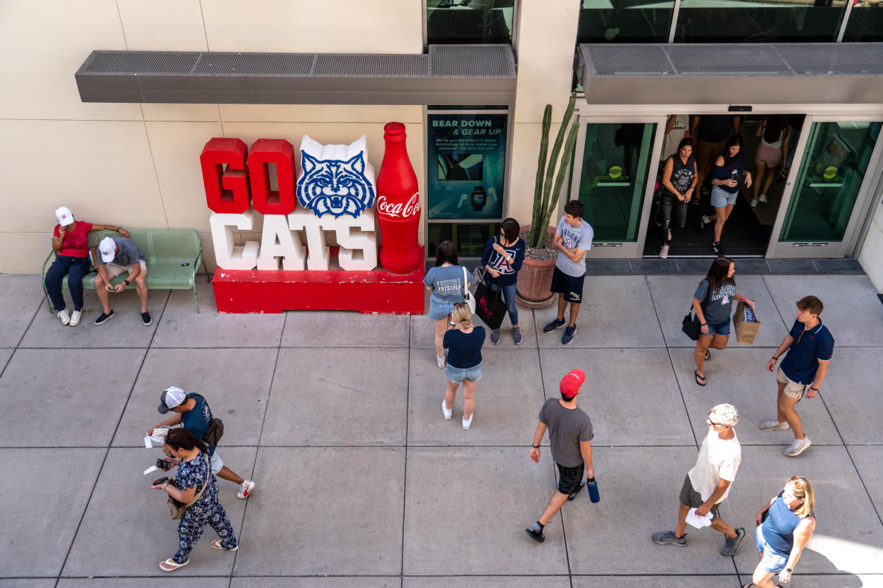 People walk through campus at the University of Arizona in Tucson on Oct. 8, 2022.