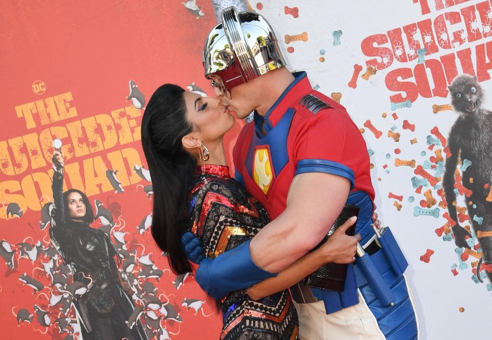 John Cena and wife Shay Shariatzadeh kiss on the red carpet at the premiere of "The Suicide Squad."