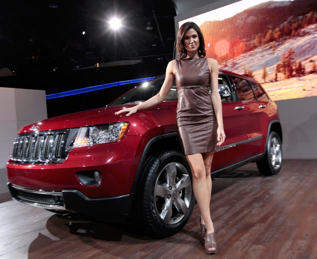 Model Alison Fiori poses next to a 2012 Jeep Grand Cherokee Limited on the final press preview day for the North American International Auto Show in Detroit, Michigan, January 10, 2012. REUTERS/Rebecca Cook