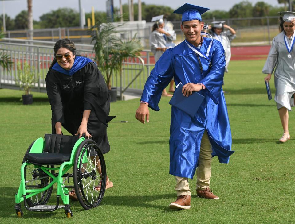 Sebastian River senior Aaron Pena receives his diploma during Sebastian Rive High School's 2022 commencement ceremony on Saturday, May 21, 2022, inside Shark Stadium, in Sebastian. â€œItâ€™s an awesome experience to see the students graduating, to celebrate with them all of the years of hard work, 13 years have been culminated today" said Sebastian River Principal Christopher Cummings.