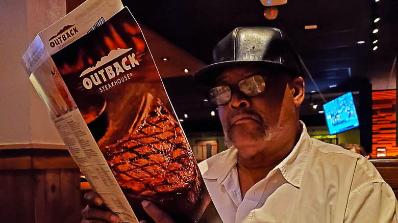 Diner holding outback menu