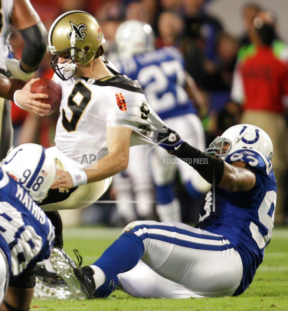 Saints quarterback Drew Brees is sacked by Colts defensive end Dwight Freeney during the first half of Super Bowl XLIV in Miami, Sunday, Feb. 7, 2010.