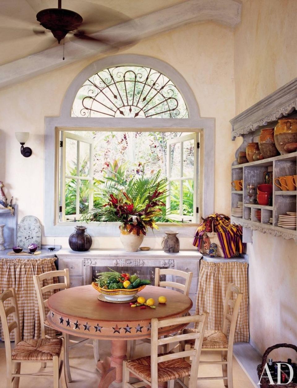 Sweet gingham fabric hides storage in this charming kitchen/dining area, found in an Isla Taboga, Panama, home.