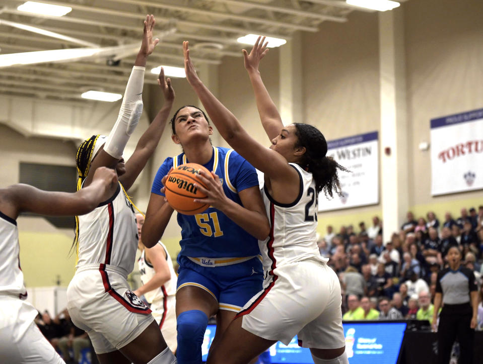 UCLA's Lauren Betts (51) goes up to shoot against UConn during the second half of an NCAA college basketball game at the Cayman Islands Classic in George Town, Cayman Islands, Friday, Nov. 24, 2023. (AP Photo/Kevin Morales)