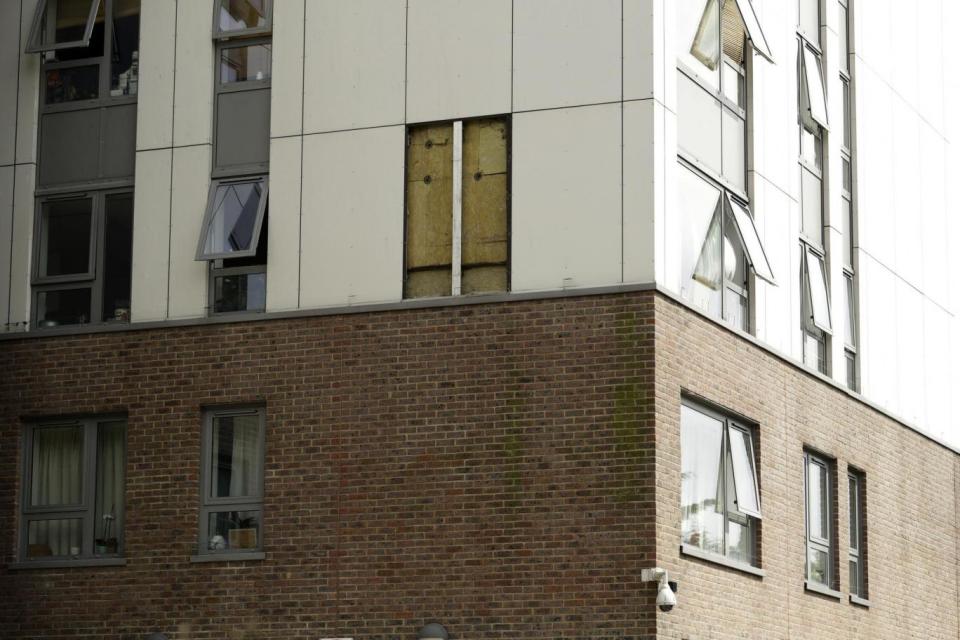 Urgent works: Part of the Burnham residential tower on the Chalcots Estate where the cladding has been (AP)