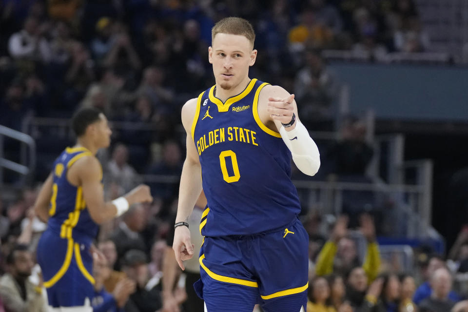 Golden State Warriors guard Donte DiVincenzo (0) gestures after shooting a 3-point basket against the Dallas Mavericks during the first half of an NBA basketball game in San Francisco, Saturday, Feb. 4, 2023. (AP Photo/Jeff Chiu)