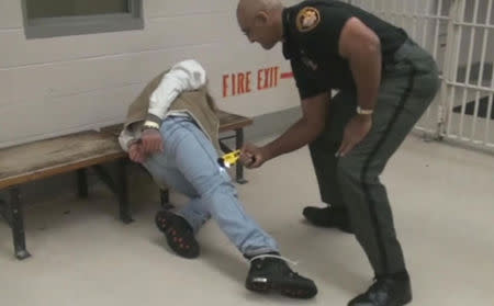 Franklin County Sergeant Mychal Turner presses a Taser gun into the leg of inmate Gregory Esmile, in Franklin County Jail, in this still image taken from video, in Columbus Ohio, December 31, 2009. Franklin County Sheriff's Office/Handout via REUTERS