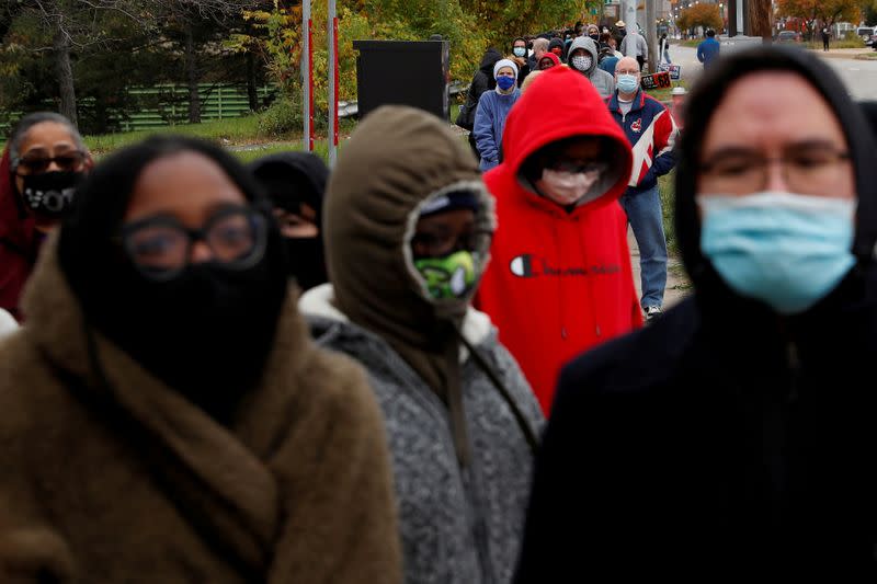 FILE PHOTO: People wait in line to cast early in-person votes at the Cuyahoga County Board of Elections in Cleveland, Ohio