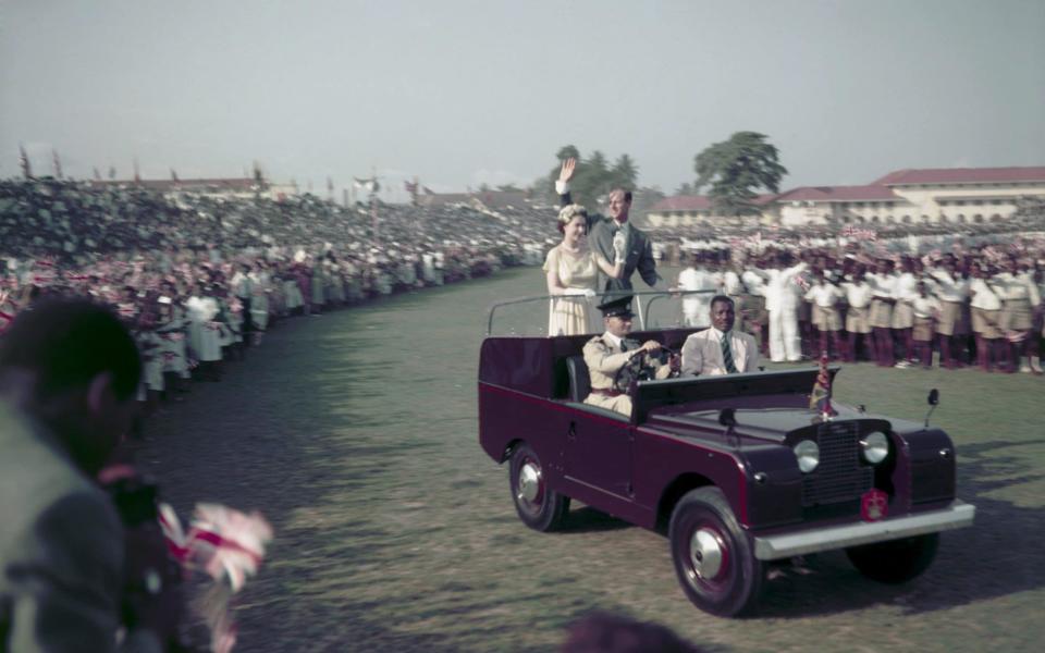 Queen Elizabeth II and Prince Philip waving from a Land Rover at a youth rally in Lagos, Nigeria in 1956 - Fox Photos /HULTON ARCHIVE 