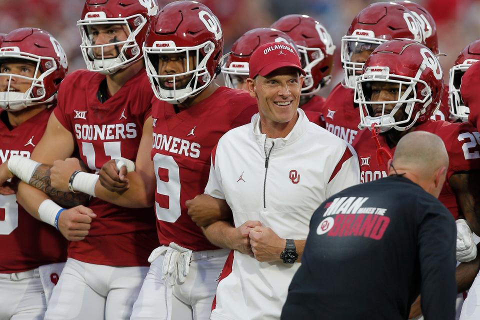 OU football coach Brent Venables walks with his team before Saturday's game against Kansas State.