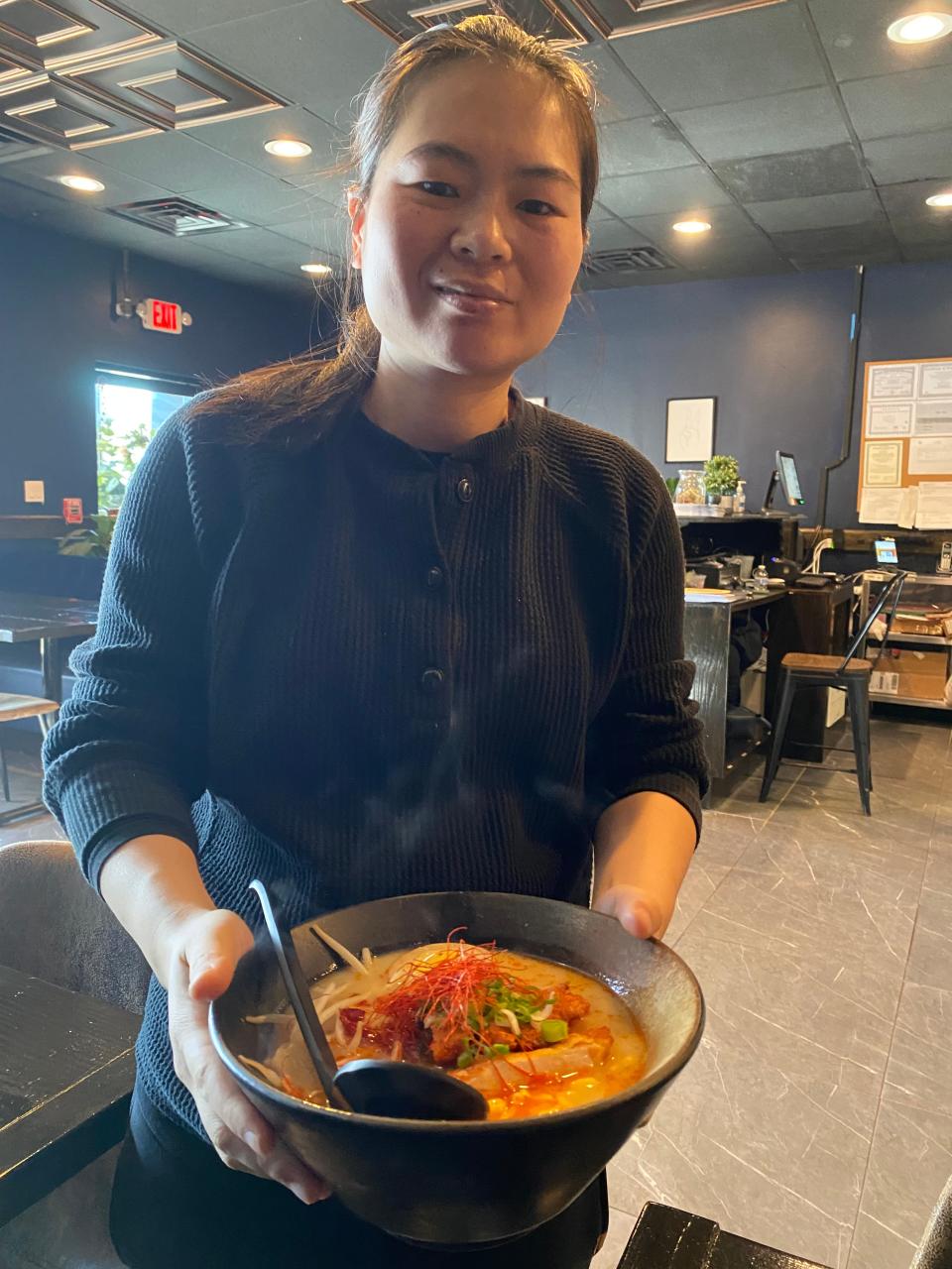 Manager Anna Zou serves an order of chicken katsu ramen at Malis Sushi & Ramen restaurant in Raynham on Thursday, Feb. 8, 2024.