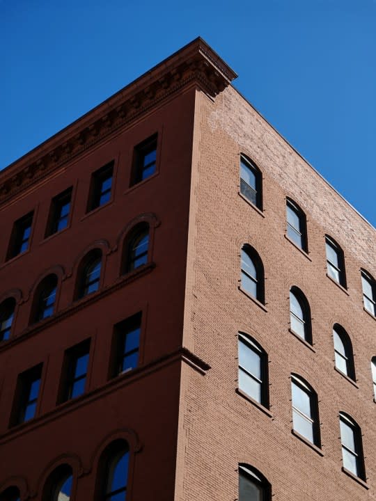 A photo of a brick building against a blue sky, taken with the Honor Magic 6 RSR.