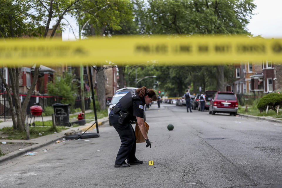 An officer collects evidence at the scene where an 8-year-old girl was shot on the 1000 block of North Monticello Avenue on Aug. 11, 2019 in Chicago. | Armando L. Sanchez—Chicago Tribune/Getty Images