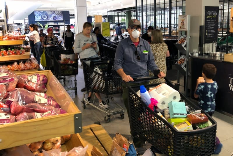 Shoppers queue to stock up on groceries ahead a nationwide lockdown called to limit the spread of coronavirus disease (COVID-19), in Cape Town