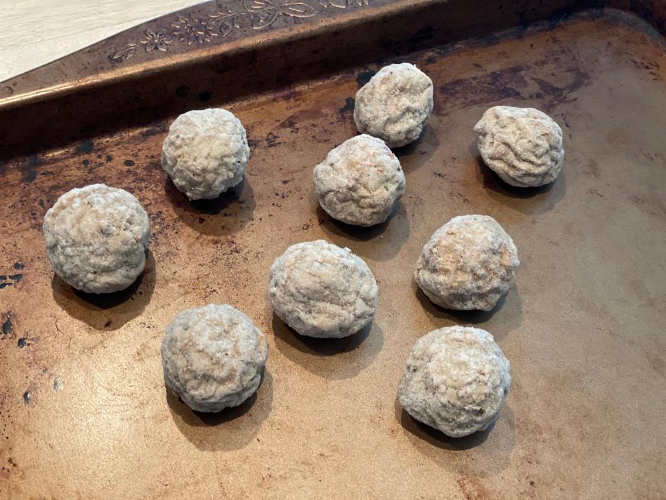 meatballs spread out on a baking sheet