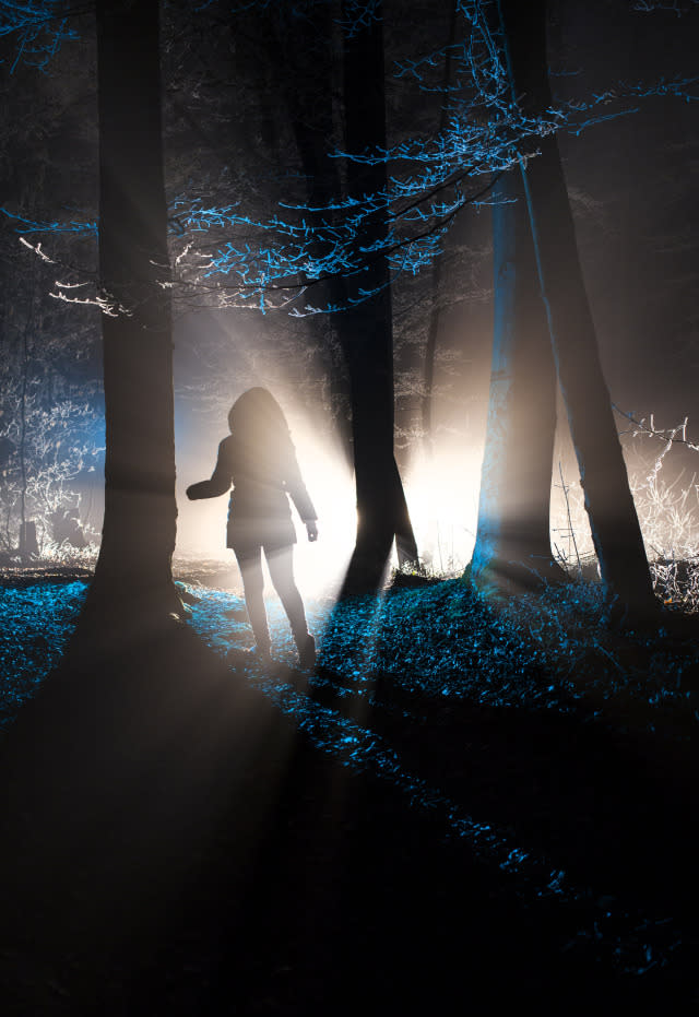 A girl in the dark forest.