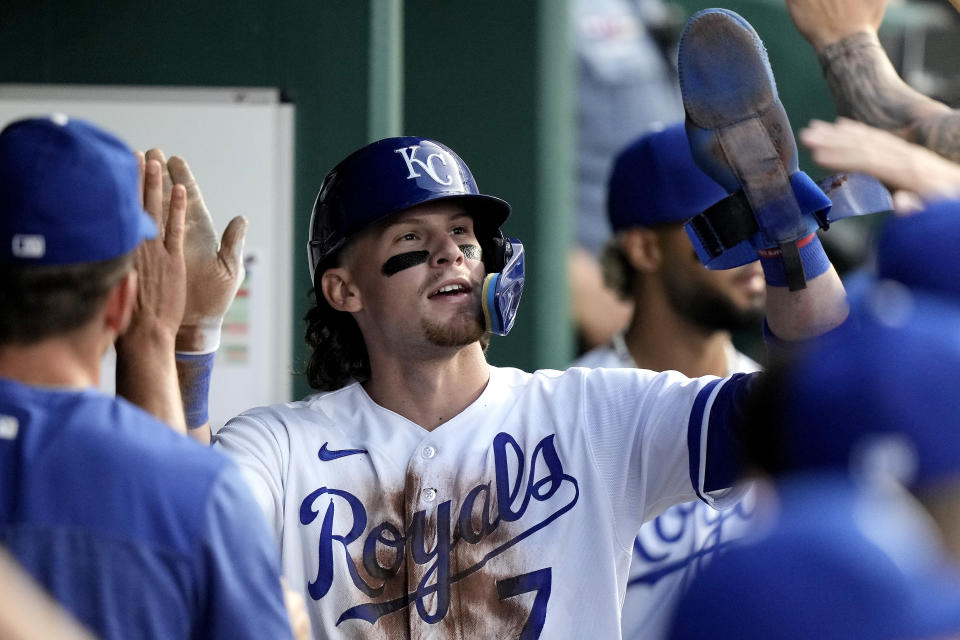 Kansas City Royals' Bobby Witt Jr. celebrates in the dugout after scoring on a single by Edward Olivares during the fifth inning of a baseball game against the Detroit Tigers Tuesday, May 23, 2023, in Kansas City, Mo. (AP Photo/Charlie Riedel)
