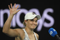 Ash Barty of Australia waves as she is interviewed after defeating Camila Giorgi of Italy in their third round match at the Australian Open tennis championships in Melbourne, Australia, Friday, Jan. 21, 2022. (AP Photo/Andy Brownbill)