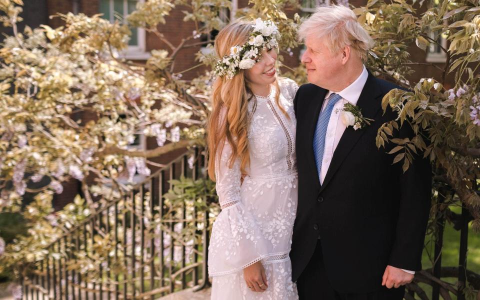 Prime Minister Boris Johnson poses with his wife Carrie Johnson in the garden of 10 Downing Street following their wedding at Westminster Cathedral - Downing Street via Getty Images/Getty Images Europe