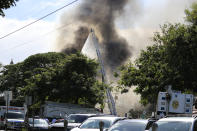 Several house fires burn in a Diamond Head neighborhood Sunday, Jan. 19, 2020, in Honolulu, following a shooting in which two police officers were shot. (AP Photo/Marco Garcia)