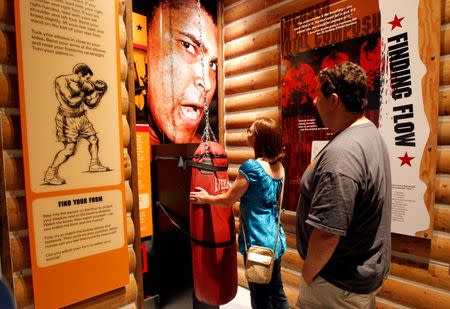 Boxing fans tour the Ali Center as they pay their respect to Muhammad Ali, the former world heavyweight boxing champion after he died at the age of 74 on Friday at City Hall in Louisville, Kentucky, U.S. June 4, 2016. REUTERS/John Sommers II