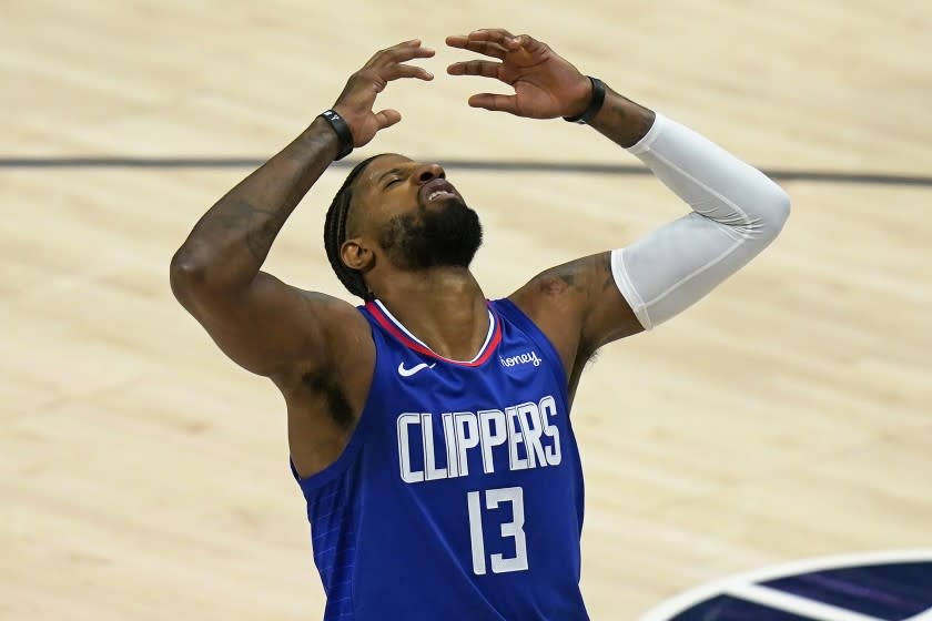 Los Angeles Clippers guard Paul George reacts after being fouled during.