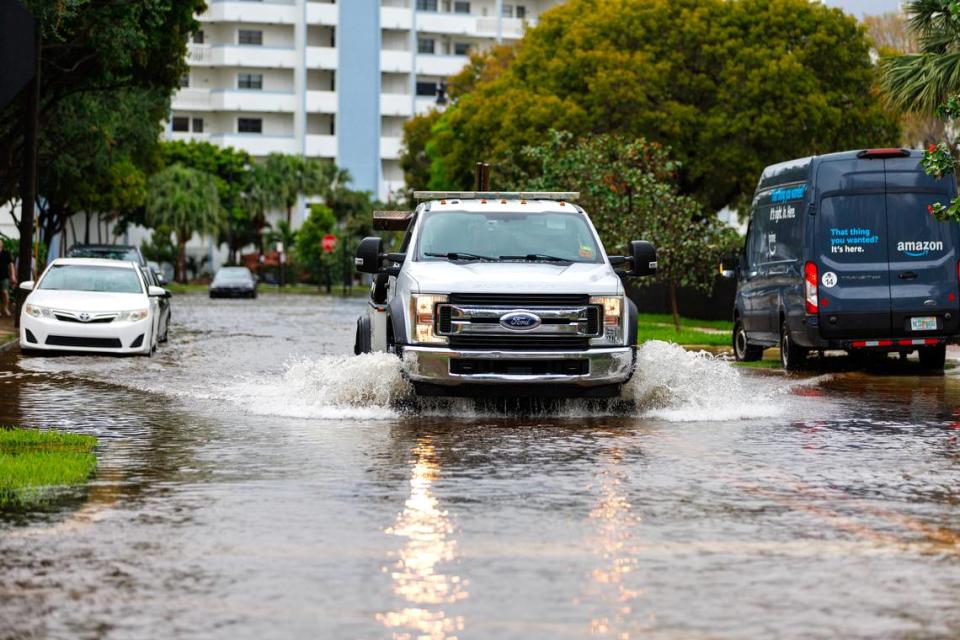 A tow truck goes through the flooded road cause by heavy rains at North Bay Rd and 179th Dr. in Sunny Isles Beach on Wednesday, April 25, 2023.
