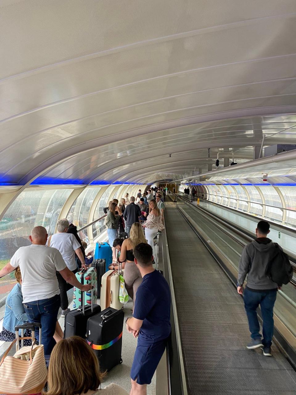 People queue at Manchester Airport, as Tui announced a “small number” of flight cancellations and delays in a blow to travel plans at the start of the half-term brea (PA)