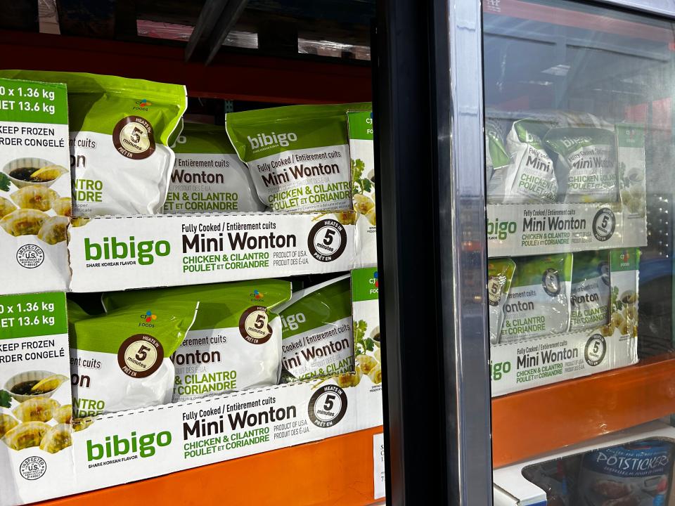 Bags on Bibigo chicken and cilantro mini wontons on a shelf at Costco.