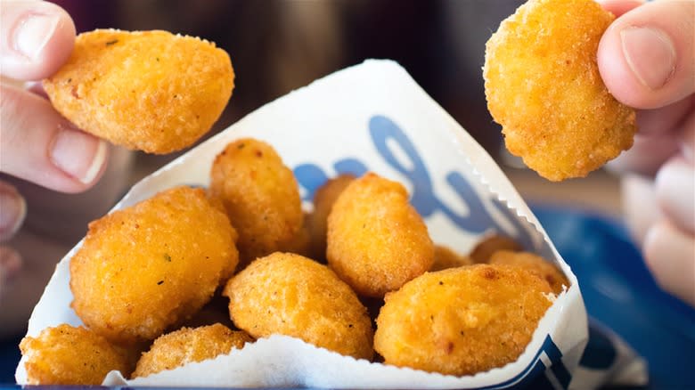 Customers holding cheese curds