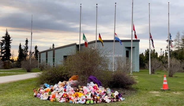 Teddy bears and toys continued to be added to the memorial long after Monday afternoon's ceremony finished. The town is also flying its flags at half-mast in memory of the children.