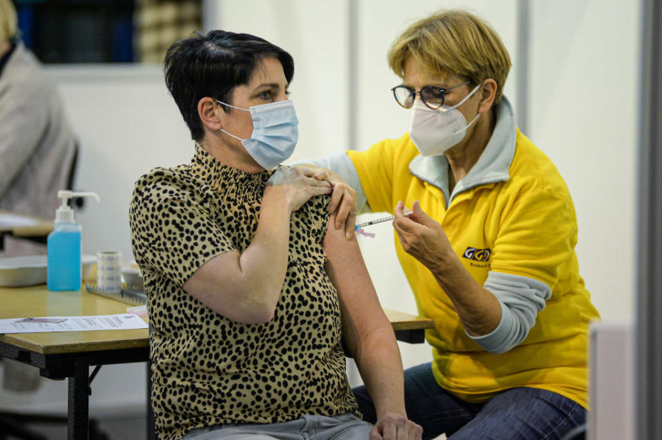 A healthcare worker is receiving the Pfizer coronavirus vaccine in the Indoor Sports Centre during the start of the COVID-19 vaccination campaign in Eindhoven, Netherlands.