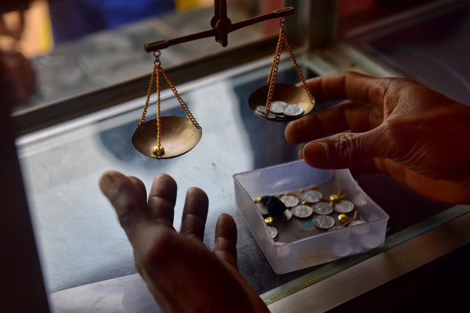 Buyer weighing gold on scale