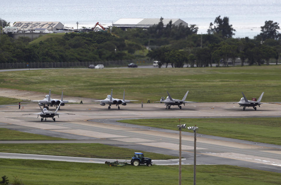 In this Aug. 14, 2012 photo, U.S. Air Force F-22 Raptors, right, and two F-15 Eagles prepare for take-off at Kadena Air Base on the southern island of Okinawa, in Japan. The deployment of a dozen F-22 stealth fighters to Japan has so far gone off without a hitch as the aircraft are being brought back into the skies in their first overseas mission since restrictions were imposed over incidents involving pilots getting dizzy and disoriented, a senior U.S. Air Force commander told the Associated Press on Thursday, Aug. 30, 2012. (AP Photo/Greg Baker)