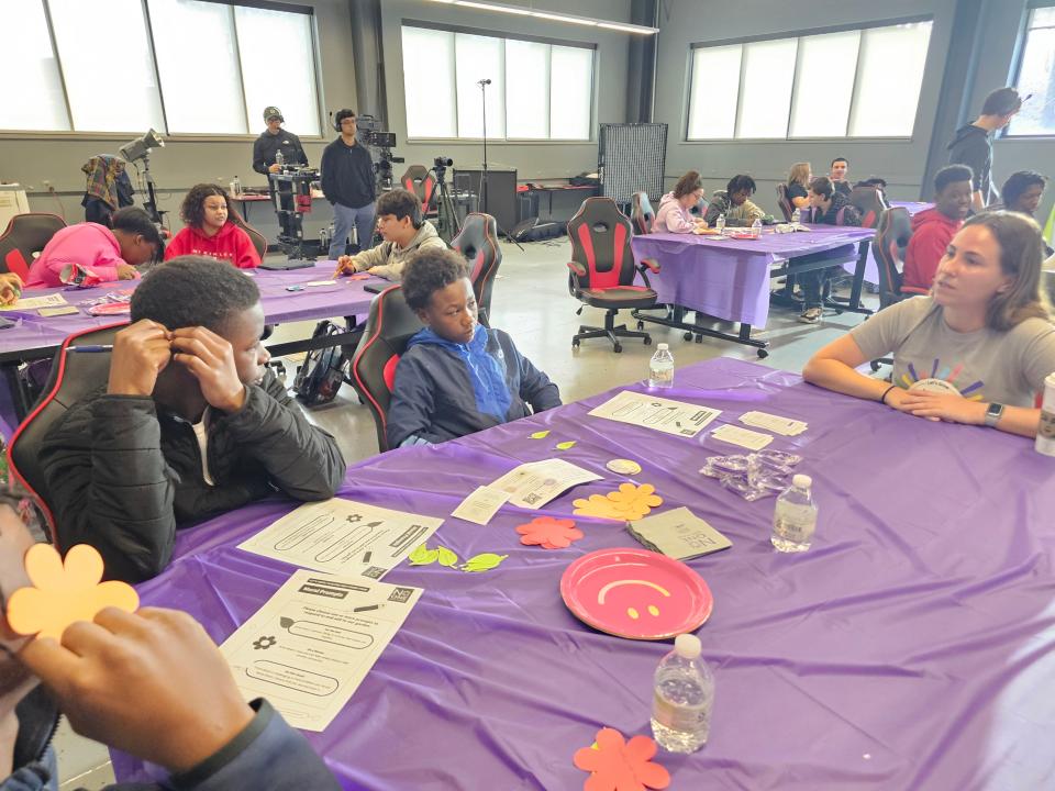 Janessa Soucy, partnership success coordinator with Beyond Differences, talks with a group of Crenshaw Middle School students about ways to make people feel included during the No One Eats Alone program.